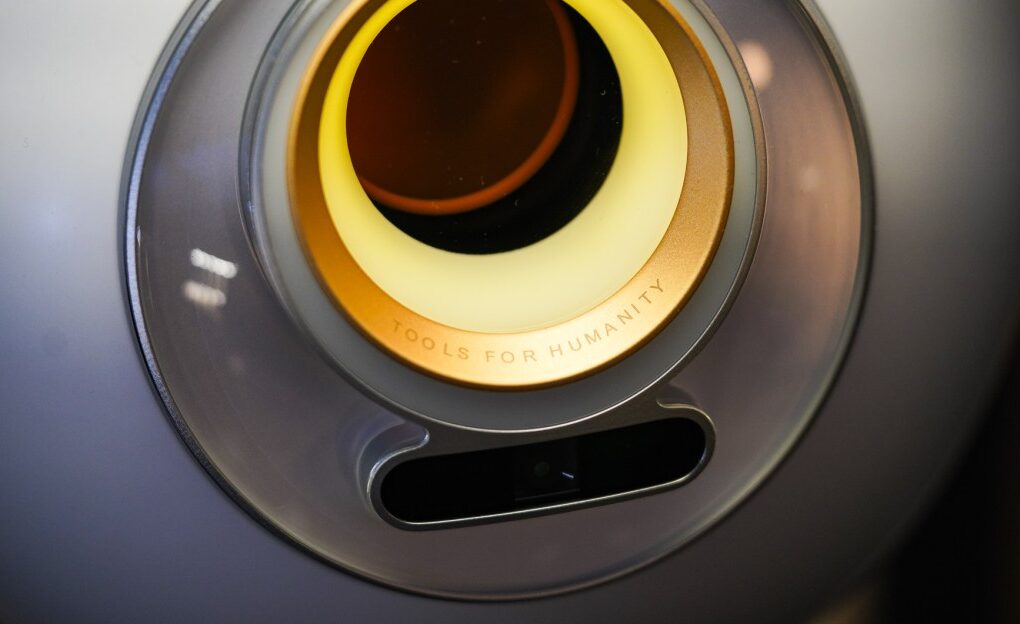 Worldcoin WLD token logo alongside a Worldcoin Orb device, symbolizing the Worldcoin US Launch and identity verification technology.