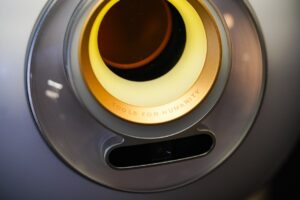 Worldcoin WLD token logo alongside a Worldcoin Orb device, symbolizing the Worldcoin US Launch and identity verification technology.